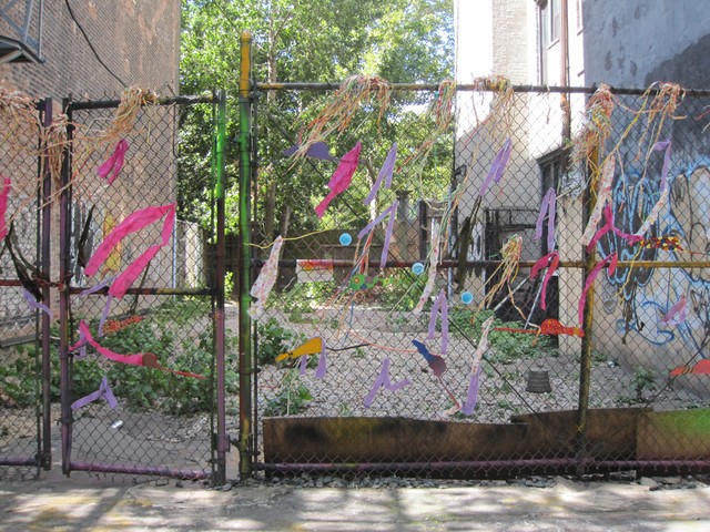 The fence in front of the lot was covered in colorful ribbons and cutouts of rats by the Lower Eastside Girls Club over the summer.