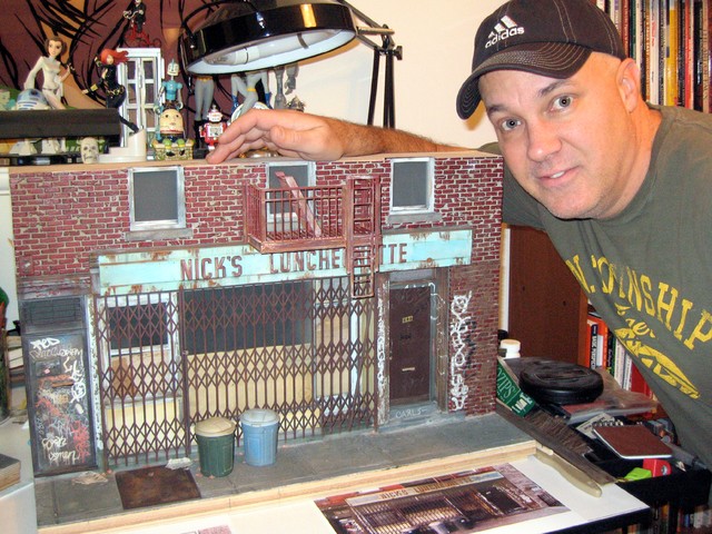 Randy Hage poses with his model of Nick's Luncheonette.