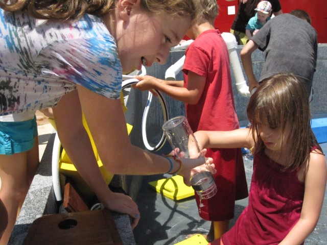 Kids used tubes and bottles to funnel water to their various projects.