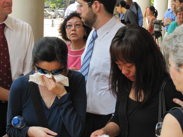 May Ng (l.) and Wana Wu, mothers of Hayley and Diego, are consoled after the emotional press conference.