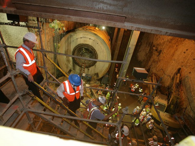 Media and city officials descend below Port Authority to where the boring machines were set to break through.