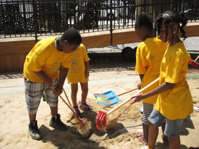 Local campers worked on a canal, using rakes to dig into the sand.