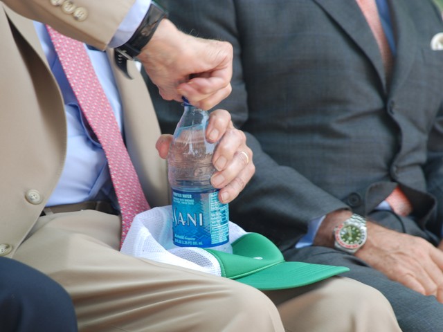 Former Manhattan District Attorney Robert Morgenthau struggles to open his Disani water bottle during the Police Athletic League Play Streets summer program opening event Wednesday. He had similar problems opening a fire hydrant for kids later in the program.