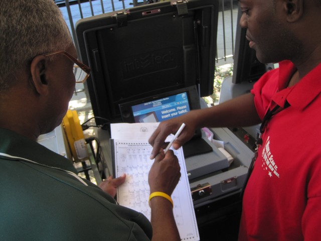 Assemblyman Keith Wright gets a demonstration of the new voting machines.