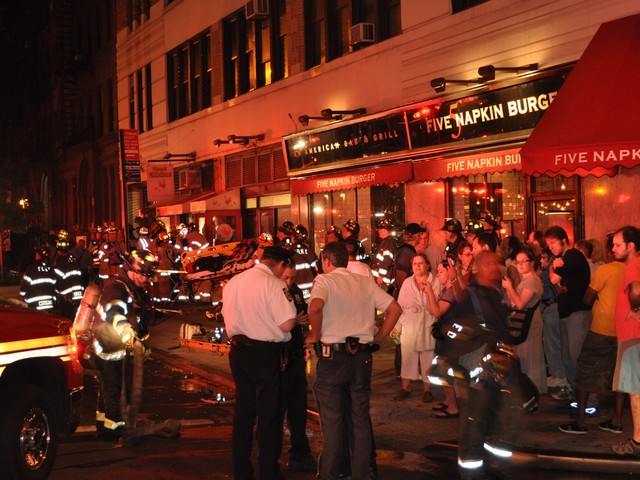 Evacuated tenants and passerby gathered at 45th and Ninth Avenue to watch firefighters battle the blaze.