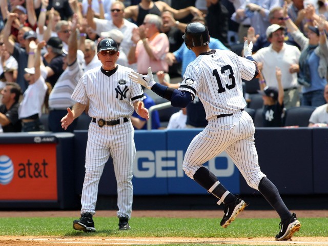 Alex Rodriguez #13 of the New York Yankees rounds the bases after hitting the 600th home run of his career in the first inning as first base coach Omar Malave #52 reacts against the Toronto Blue Jays on August 4, 2010 at Yankee Stadium.
