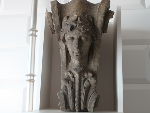 A pair of c.1900 terra cotta Pediment Keystones are perched atop the built-in bedroom cabinets.