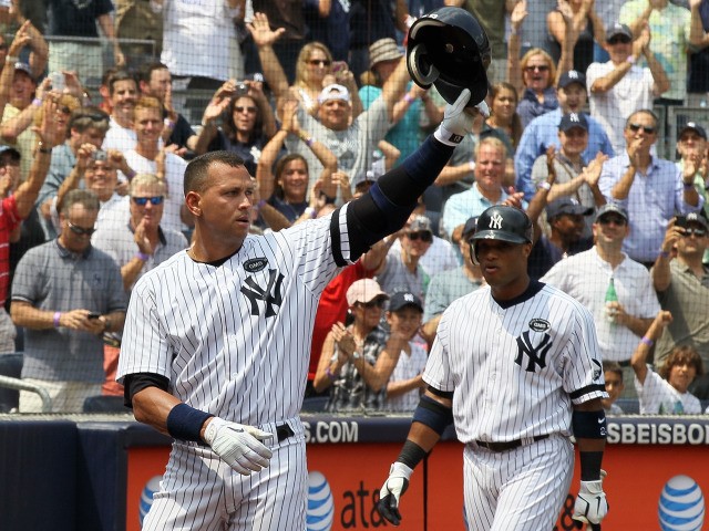 Alex Rodriguez salutes the crowd after hitting his 600th career home run in the first inning against the Toronto Blue Jays as teammate Robinson Cano #24 looks on on August 4, 2010 at Yankee Stadium.