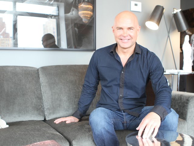 House Planner Jack Thomasson sits on the couch in the living room of the first HGTV urban residence giveaway.