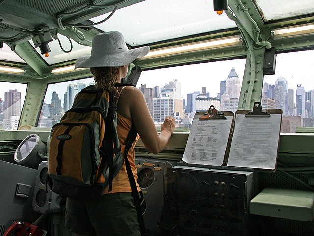 A visitor stares out the captain's helm toward the city.