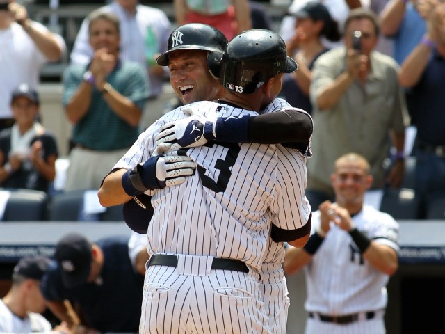 Alex Rodriguez of the New York Yankees celebrates with teammate Derek Jeter after hitting the 600th home run of his career in the first inning against the Toronto Blue Jays on August 4, 2010 at Yankee Stadium.