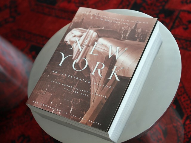 The apartment is filled with complimentary books about New York.