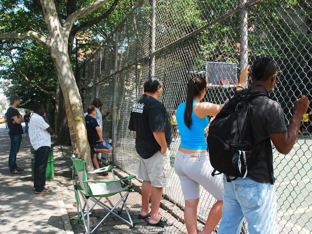 Spectators watch girl's teams Mika and the NYC Lady Warriors face off at The Cage.