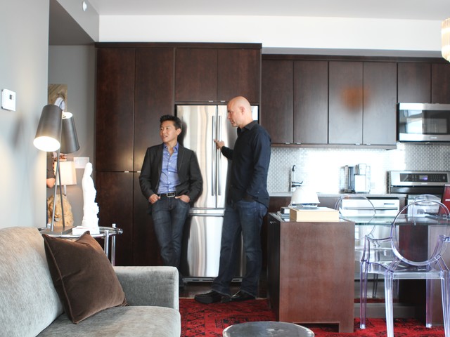 HGTV designers Vern Yip and Jack Thomasson stand in the kitchen/foyer of the million dollar condo.