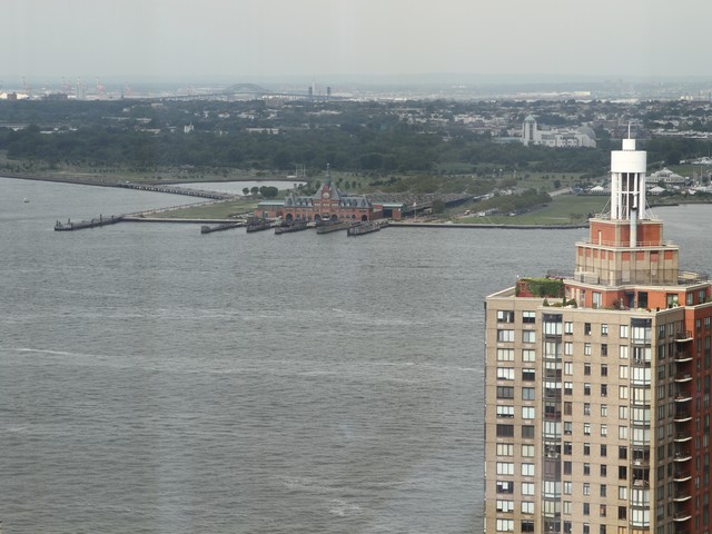 The skyline shows through two floor-to-ceiling glass windows.