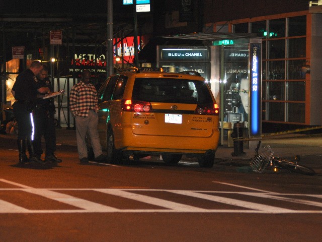Police talk to the cab driver after the accident.