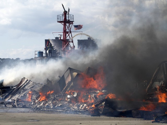 Firefighters battle a blaze on a Hudson River pier on New York City's west side after fire broke out in trash filled containers on a pier operated by the New York City Sanitation Department, Saturday, Sept. 4, 2010. More than 130 firefighters responded to the smoky fire.