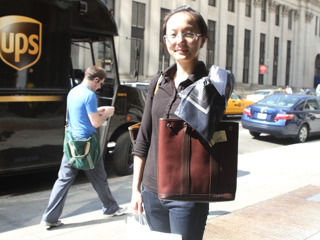 Shopper Pauline Pan shows off her new bag and scarf that she bought at the Hermes sample sale Wednesday.