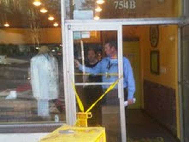 A Department of Buildings inspectors examines the crack inside the building.