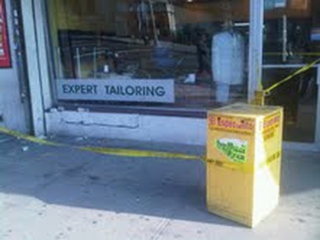 A Department of Buildings inspectors examines the crack inside the building.
