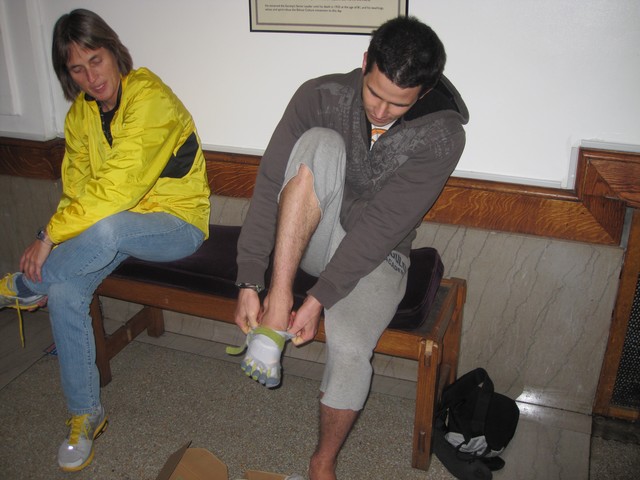 A potential customer tries on a pair of Vibram Five Finger running shoes in the lobby of the NY Society for Ethical Culture.