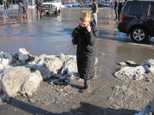 The puddle was no match for this woman, who was too busy chatting on her cell phone to notice.