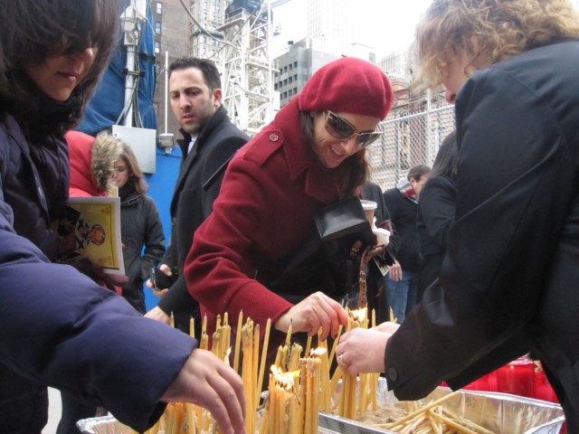 Congregants lit candles as they entered the World Trade Center site for the service on Sunday.
