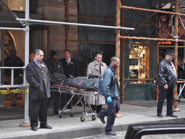 Mark Madoff's body is brought out of the Mercer Street apartment Saturday afternoon.