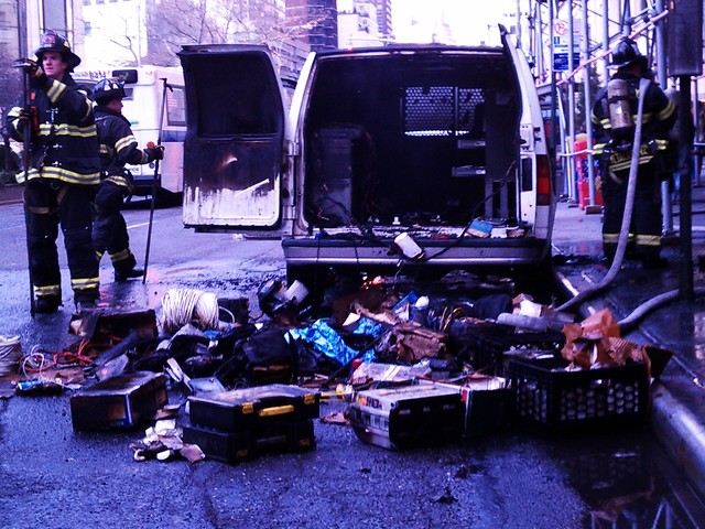 The van's contents were strewn onto Broadway as the FDNY worked to put out the fire.