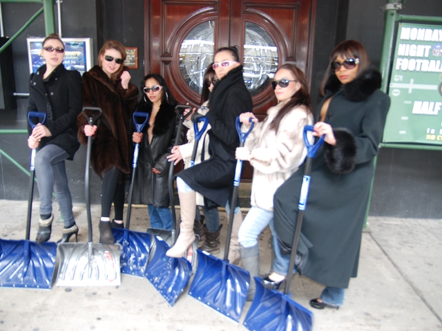 A group of exotic dancers from the Cheetah Club on West 43rd Street shoveled snow outside their club Wednesday.