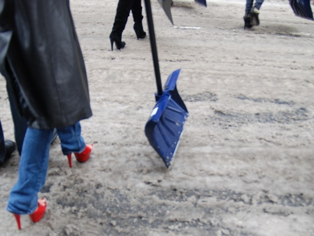 Exotic dancers wore winter jackets and work shoes to shovel snow outside of their Gentleman's Club Wednesday.