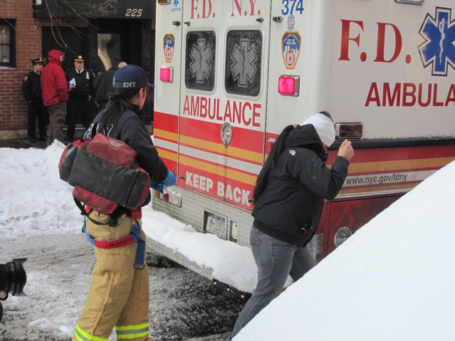 A woman with a bandage on her head walked to an ambulance outside the building where the shooting occurred.