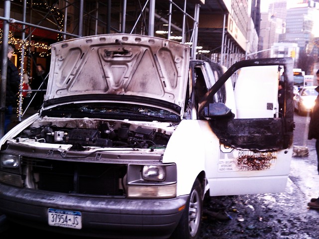 The driver's side door was blackened after the van caught fire.