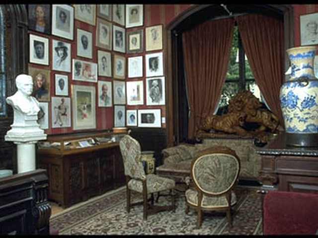 The National Arts Club's Music Room with portraits of Isaac Stern, Tennessee Williams, Toni Morrison and others