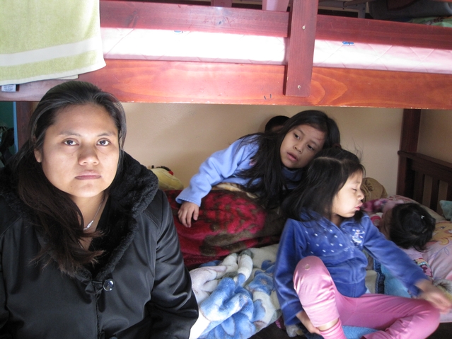Judelia Nicolas's kids stay wrapped in blankets for warmth.