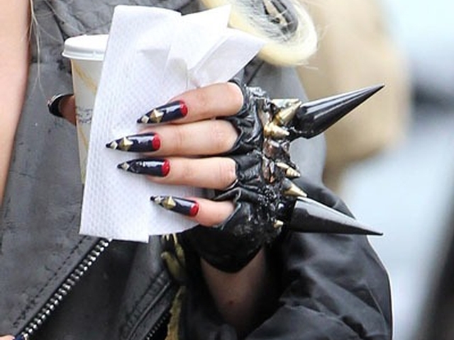 Lady Gaga's killer manicure included red and black pointy nails with metal studs and a pair of black fingerless spiked gloves.