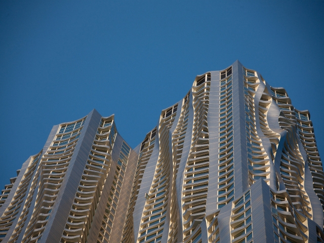 The tower's rippling stainless steel facade looks shines in the sun.