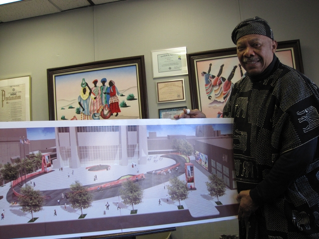 Willie Walker, general manager of the Harlem State Office Building, with a rendering of the plaza.