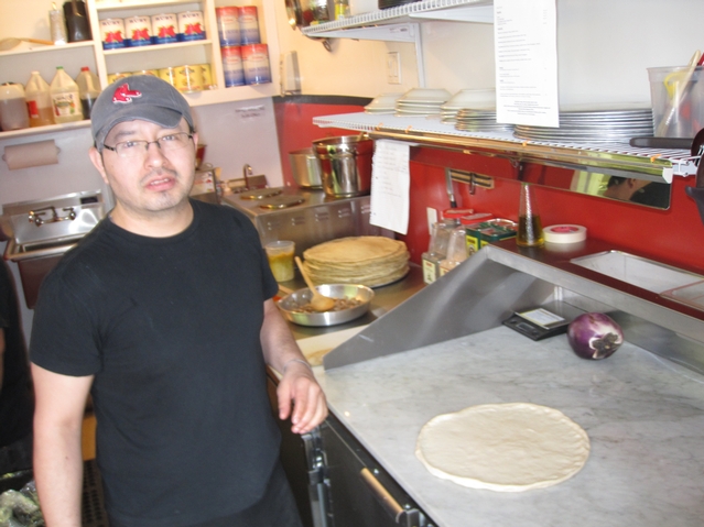 Bad Horse chef and business partner Omar Guzman prepares to work on a piece of dough in preparation for Friday's grand opening.
