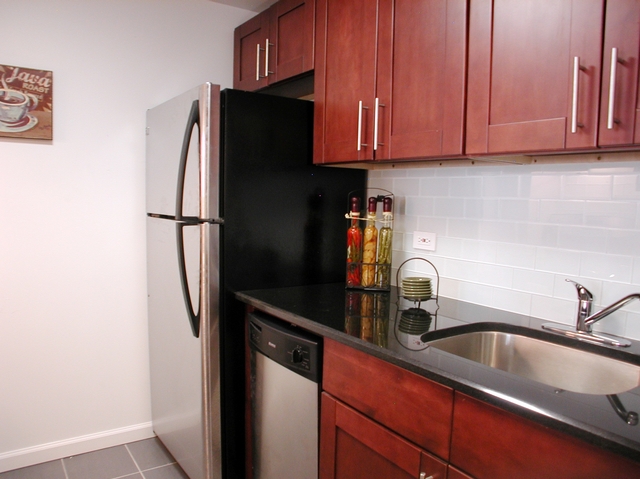 The kitchens at Hudson 192 have dark cherry Shaker-style cabinets with German hinges and soft-self-close drawers and doors.