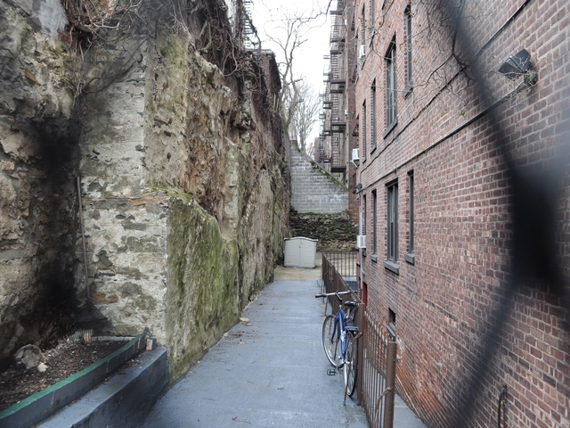 View of north portion of wall seen from fencing at 558 W. 218th Street.