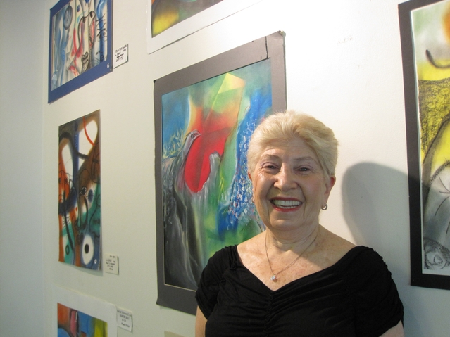 Barbara Lerner-Linder in front of some Winston Saoli's works.
