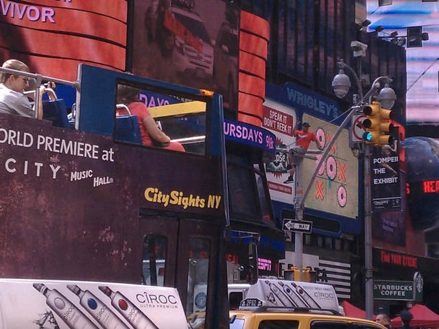 A man climbed a light post in Times Square on Tuesday.