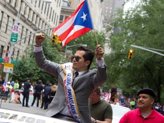 Funnyman John Leguizamo, the parade's global ambassador to the arts, gives a wave.