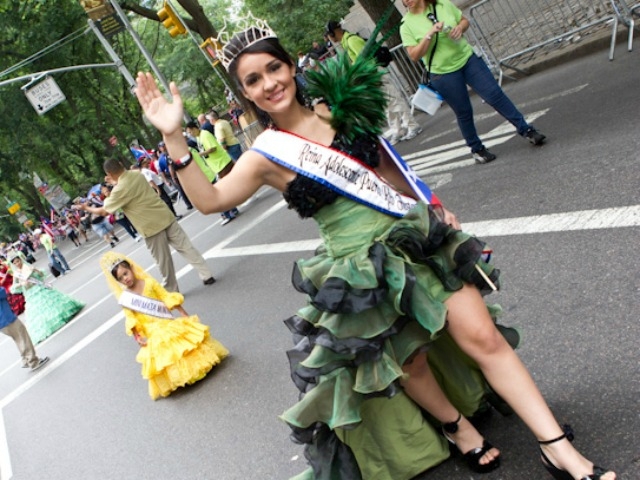 A beauty queen marches up the parade route.