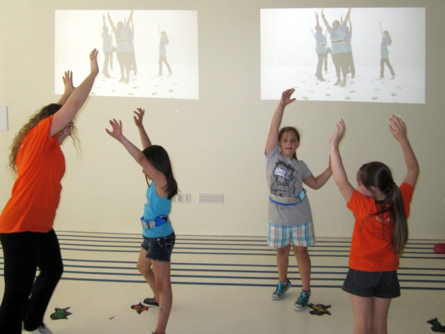 Kids follow instructions from on-screen dancers.