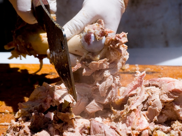 Removing the meat from the bone at the 4th Annual Big Apple BBQ.