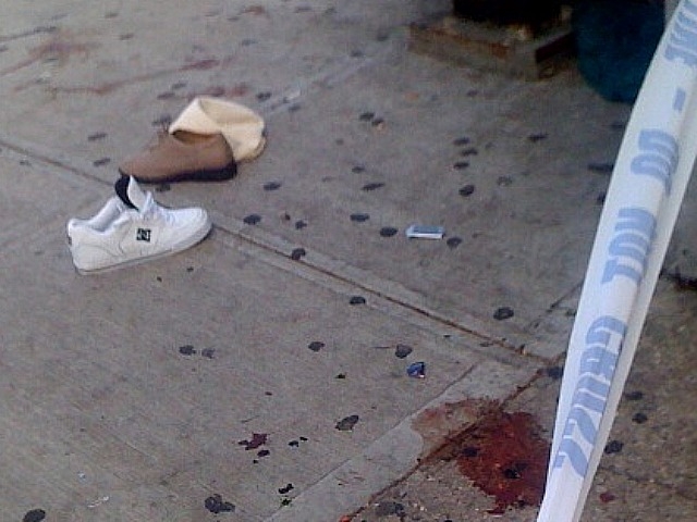 The shoes of a Harlem woman were left behind on the blood-stained sidewalk after she was struck by a car.