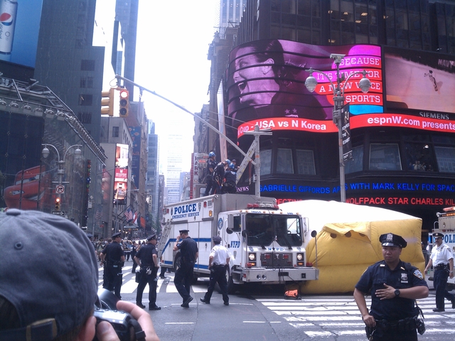 Police handcuffed a man after he climbed down from a light pole Tuesday morning.