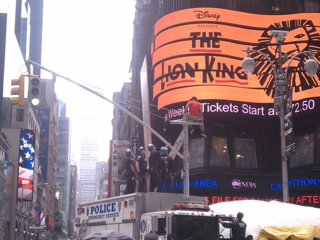 A man on a light pole in Times Square on Tuesday.